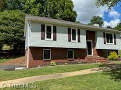 3569 Merry Ridge Rd, Tobaccoville, NC 27050 - bi-level home with a front yard