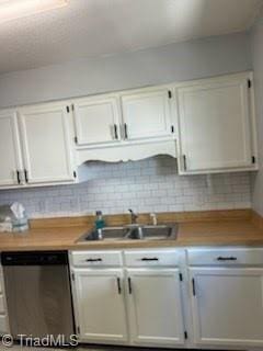 3569 Merry Ridge Rd, Tobaccoville, NC 27050 - kitchen with dishwasher, a sink, white cabinets, and decorative backsplash