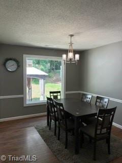 3569 Merry Ridge Rd, Tobaccoville, NC 27050 - dining space with baseboards, a chandelier, a textured ceiling, and wood finished floors