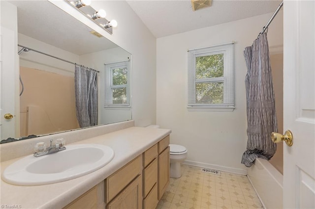 full bathroom featuring shower / tub combo, vanity, and toilet