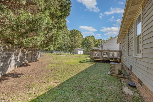 view of yard featuring a deck and central AC unit