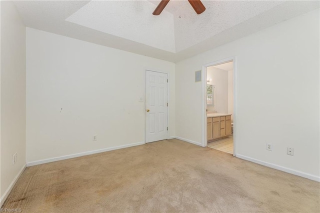 carpeted empty room with a textured ceiling and ceiling fan