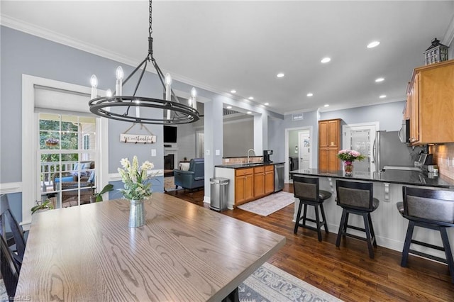 8483 Austin Hill Ln, Tobaccoville, NC 27050 - dining area with a chandelier, crown molding, recessed lighting, and dark wood-type flooring