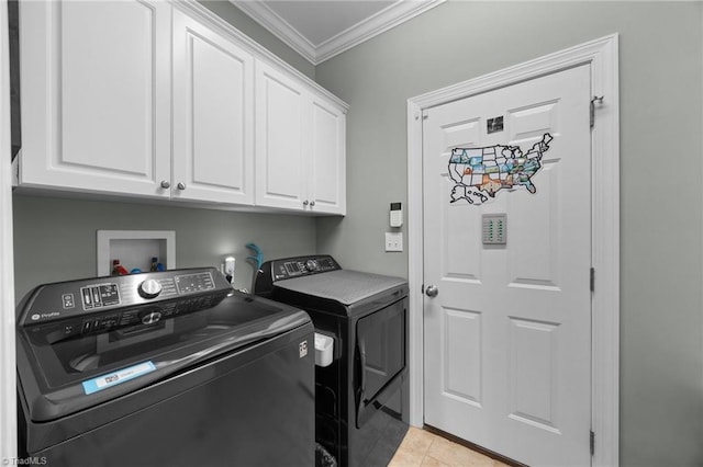 8483 Austin Hill Ln, Tobaccoville, NC 27050 - laundry room featuring washer and clothes dryer, crown molding, cabinet space, and light tile patterned floors