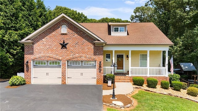 8483 Austin Hill Ln, Tobaccoville, NC 27050 - view of front of house with a porch, asphalt driveway, brick siding, and roof with shingles