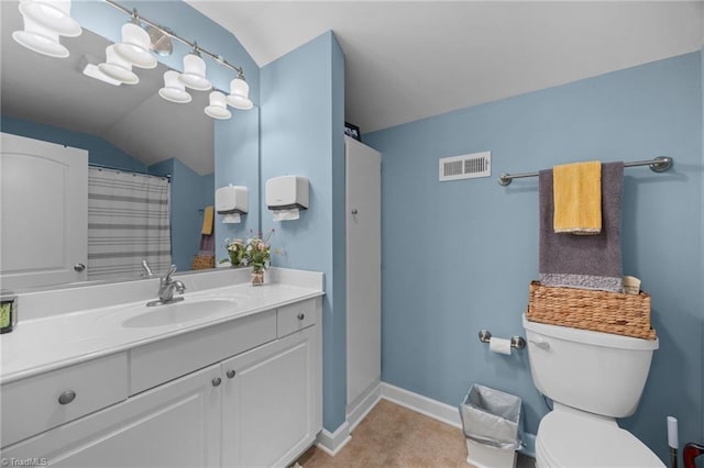 8483 Austin Hill Ln, Tobaccoville, NC 27050 - bathroom featuring vaulted ceiling, vanity, and tile patterned floors