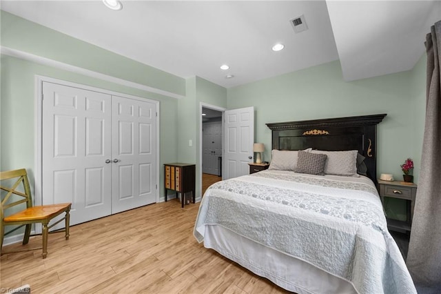 8483 Austin Hill Ln, Tobaccoville, NC 27050 - bedroom featuring wood finished floors, a closet, and recessed lighting