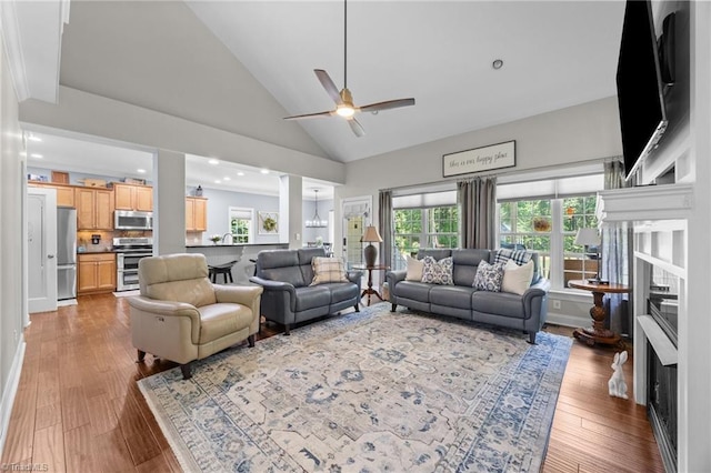 8483 Austin Hill Ln, Tobaccoville, NC 27050 - living area with a fireplace, a ceiling fan, hardwood / wood-style floors, high vaulted ceiling, and recessed lighting