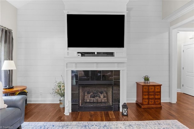 8483 Austin Hill Ln, Tobaccoville, NC 27050 - living room featuring wood finished floors, wooden walls, and a tiled fireplace
