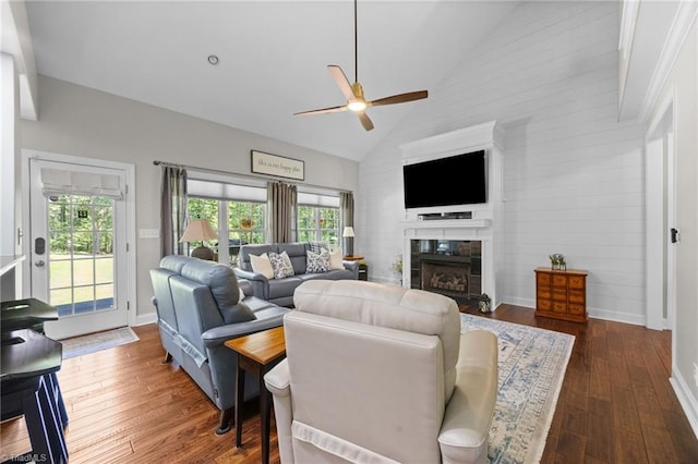 8483 Austin Hill Ln, Tobaccoville, NC 27050 - living area featuring vaulted ceiling, ceiling fan, a tile fireplace, and wood finished floors