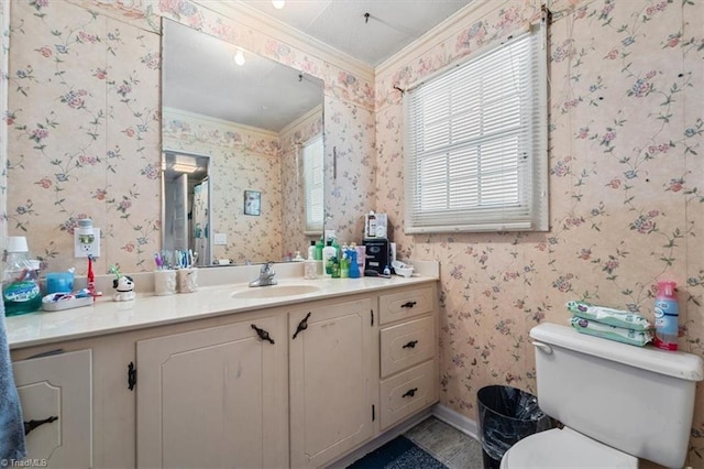 bathroom featuring plenty of natural light, vanity, toilet, and ornamental molding