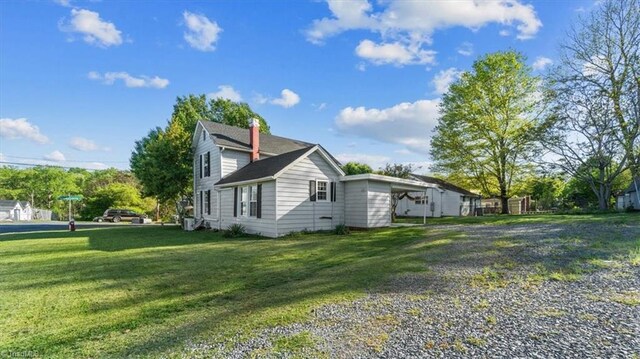 view of side of home featuring a yard