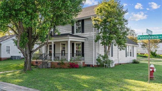 view of front facade featuring a front lawn, covered porch, and central AC unit