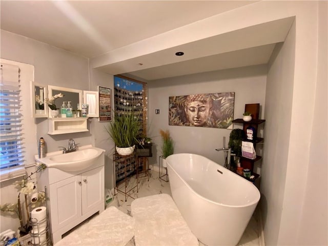 1415 E 4th St, Winston-Salem, NC 27101 - full bath featuring vanity, a soaking tub, and marble look tile flooring