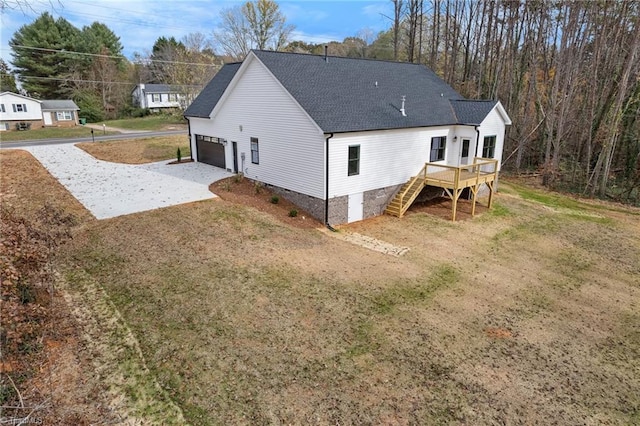 exterior space with a wooden deck, a garage, and a yard