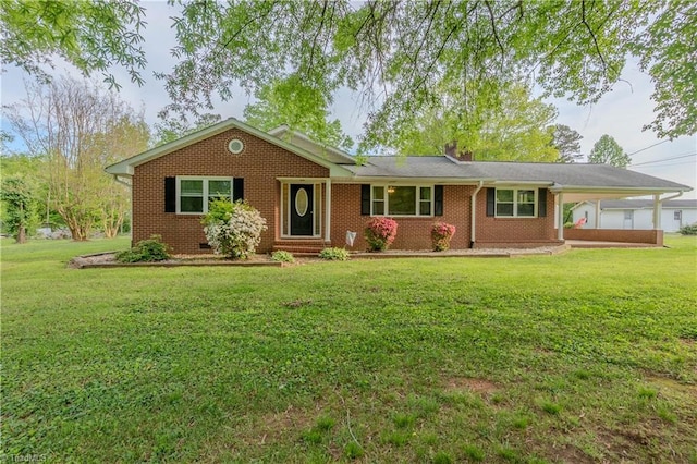 ranch-style home with brick siding, a front lawn, and an attached carport