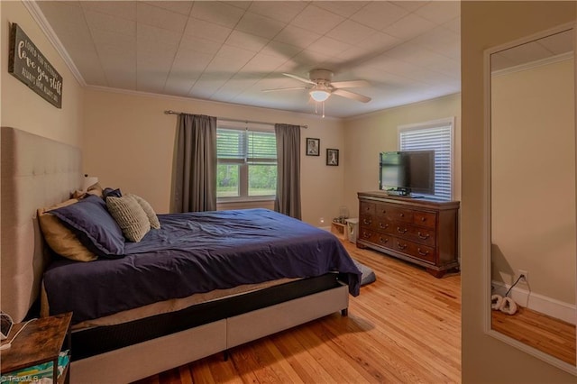 bedroom featuring wood finished floors, ceiling fan, and crown molding