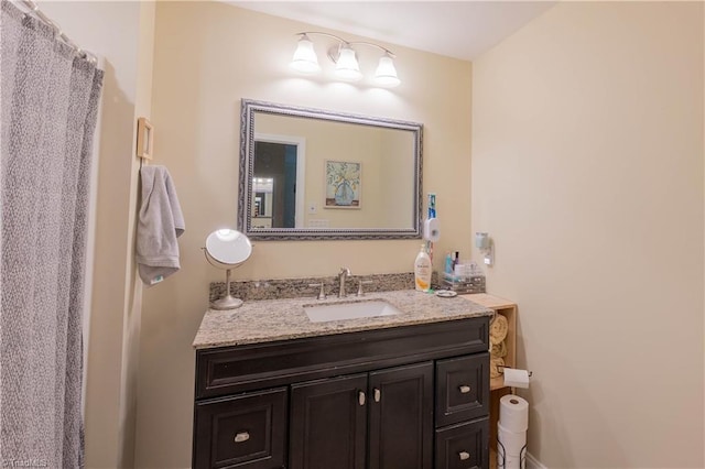 bathroom featuring vanity and a shower with shower curtain