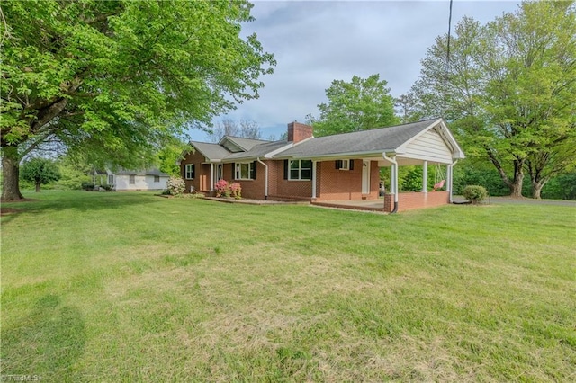 back of property featuring brick siding, a lawn, a porch, and a chimney