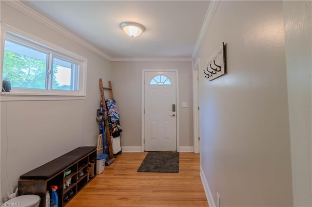 foyer entrance featuring light wood-type flooring, baseboards, and crown molding