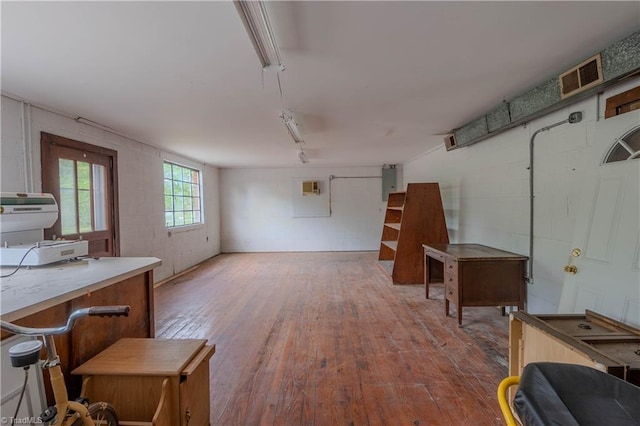 interior space featuring hardwood / wood-style flooring, electric panel, and visible vents