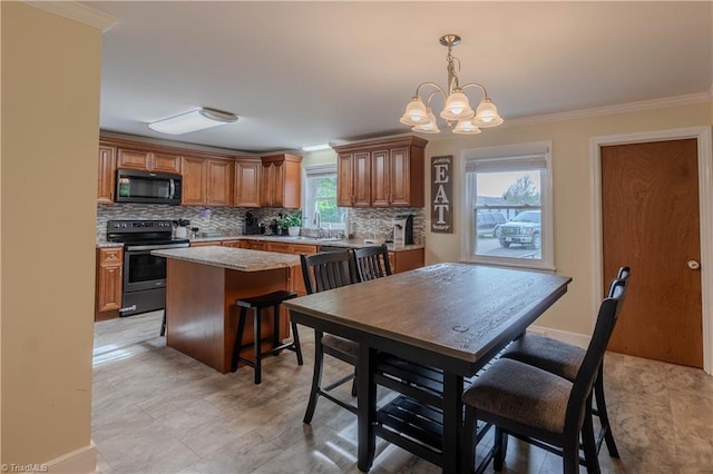 dining area with crown molding, baseboards, and an inviting chandelier