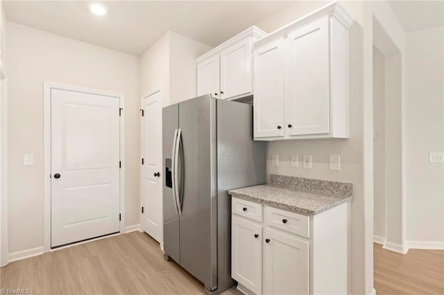 1047 Russell Dr, Winston-Salem, NC 27127 - kitchen with light wood-type flooring, white cabinets, and stainless steel fridge