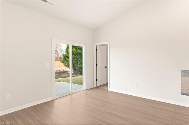 1047 Russell Dr, Winston-Salem, NC 27127 - spare room with baseboards, visible vents, and wood finished floors