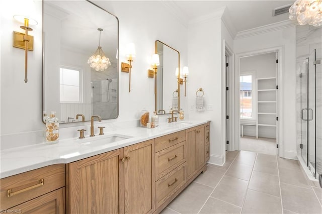 full bathroom featuring crown molding, a healthy amount of sunlight, and a sink