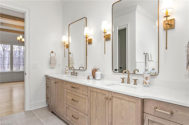 full bath with double vanity, ornamental molding, tile patterned flooring, and a sink