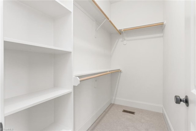 walk in closet with light carpet and visible vents