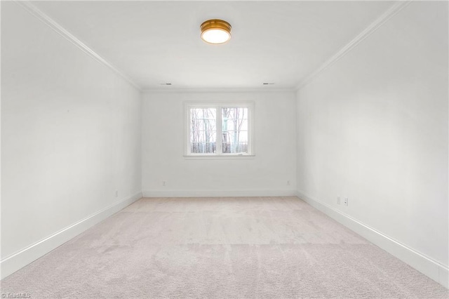 unfurnished room featuring ornamental molding, light colored carpet, and baseboards