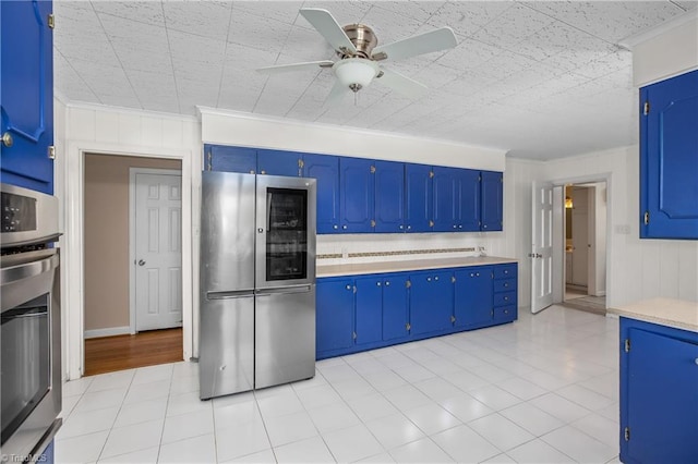 kitchen featuring ceiling fan, light countertops, crown molding, and stainless steel appliances