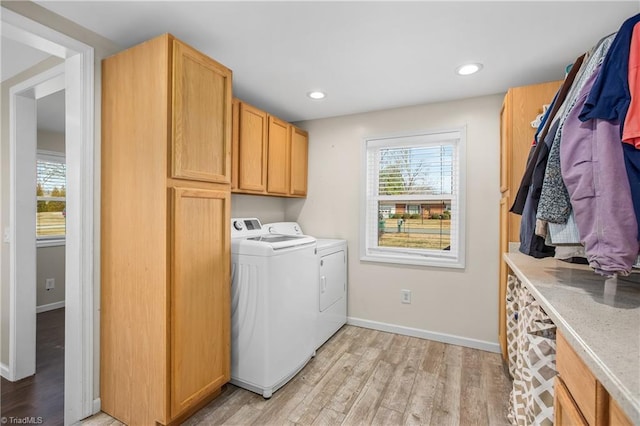 laundry area with independent washer and dryer, light wood-style flooring, recessed lighting, cabinet space, and baseboards