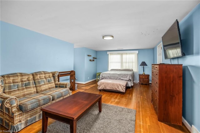 bedroom featuring light wood-style flooring and baseboards