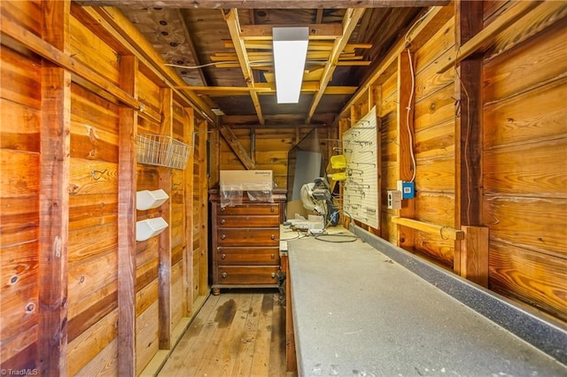 hallway featuring hardwood / wood-style flooring and wood walls