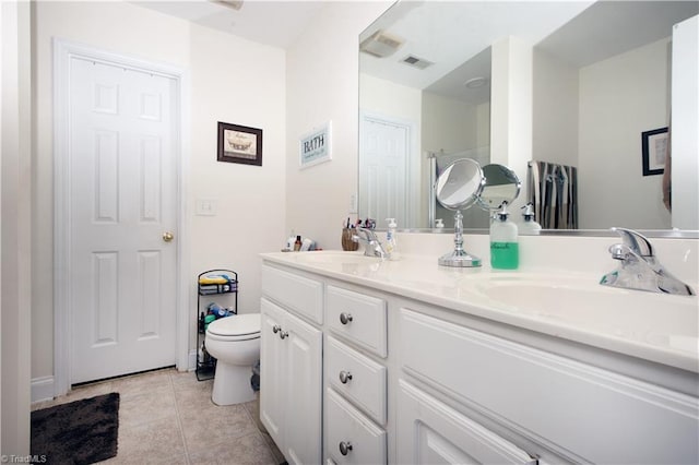 full bathroom featuring visible vents, double vanity, toilet, tile patterned floors, and a sink