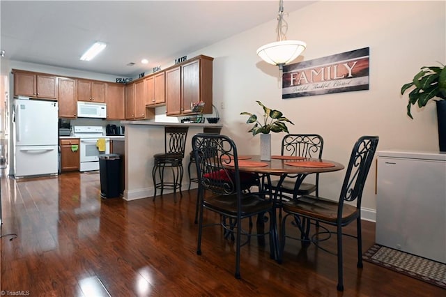 dining area featuring baseboards, recessed lighting, and dark wood-type flooring