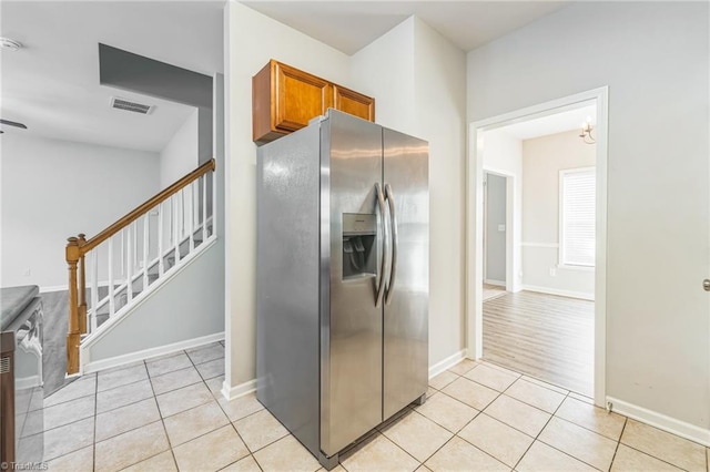 kitchen with light hardwood / wood-style flooring and stainless steel refrigerator with ice dispenser