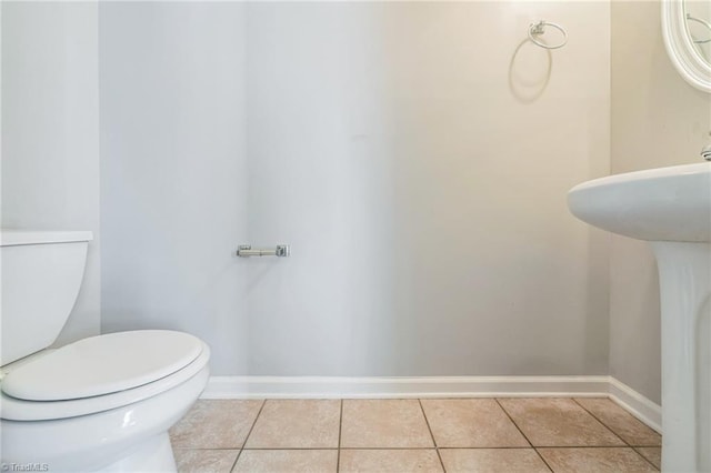 bathroom featuring toilet and tile patterned flooring