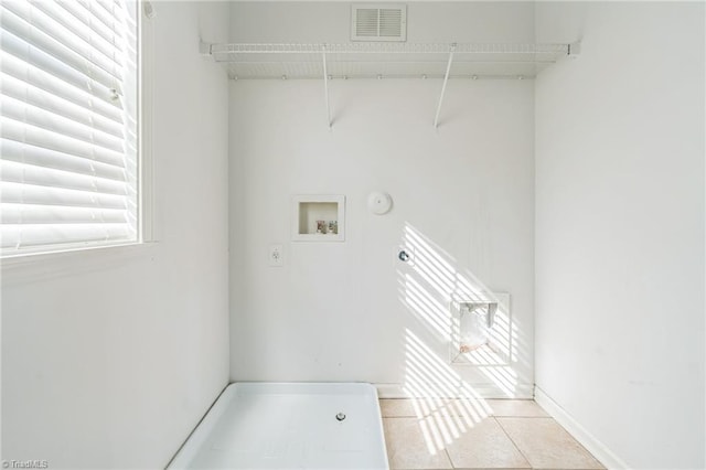 washroom featuring light tile patterned flooring and hookup for a washing machine