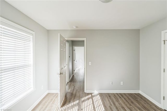 unfurnished room with light hardwood / wood-style flooring