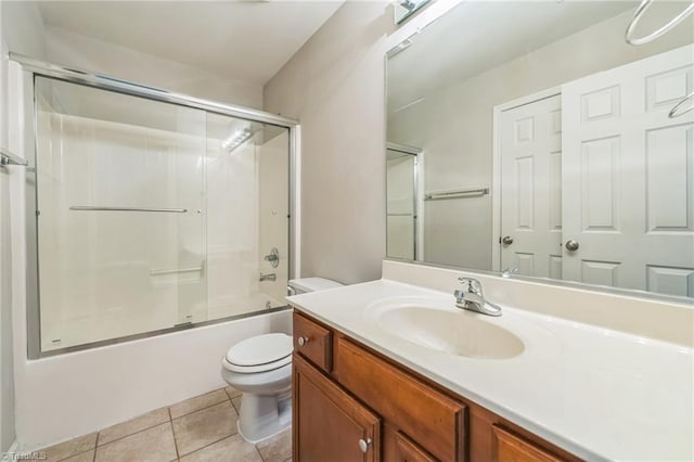 full bathroom with vanity, enclosed tub / shower combo, toilet, and tile patterned flooring