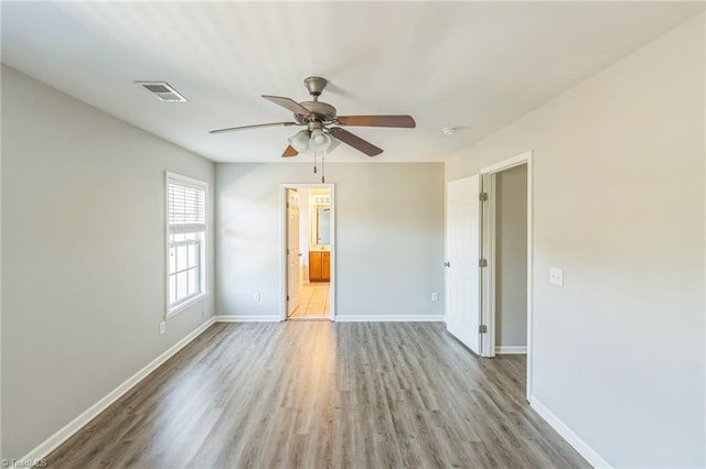 unfurnished room with ceiling fan and light wood-type flooring