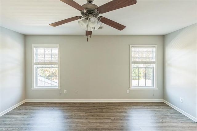 spare room with ceiling fan, hardwood / wood-style flooring, and plenty of natural light