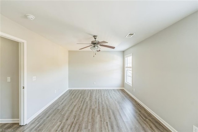 empty room featuring ceiling fan and light hardwood / wood-style flooring