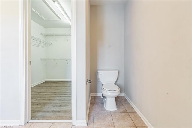 bathroom featuring hardwood / wood-style flooring and toilet