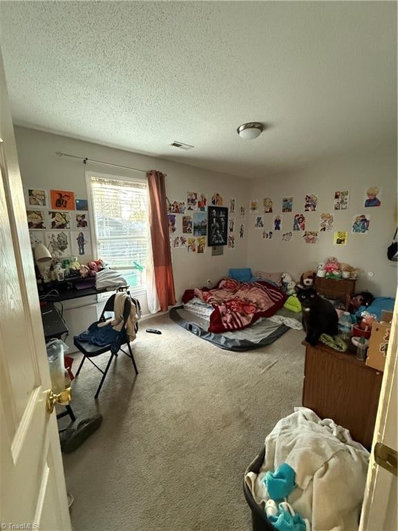 carpeted bedroom featuring a textured ceiling