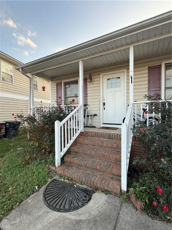 property entrance featuring covered porch