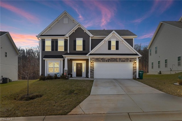 craftsman-style house with a garage, a yard, and cooling unit